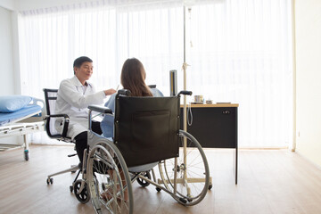 Doctor And Patient Discussing While Sitting At Hospital