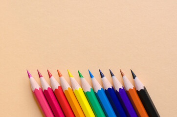Color pencils isolated on cream background. inclined