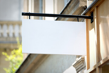 Blank sign board on a shop wall - 374314189