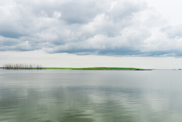 Green Bay Wisconsin shoreline with cloud reflections in the water on a calm day 