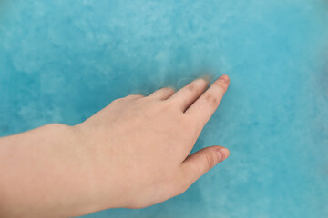 Recycling material of papers. Paper in blue water. Woman hand with recycling paper in water. Selective and soft focus