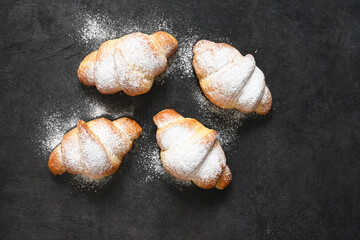 Croissants on a black concrete table. View from above.