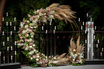 Beautiful round wedding arch decorated with flowers and greenery outdoors, copy space. Decorations...