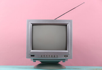 Retro old tv set on pink background.