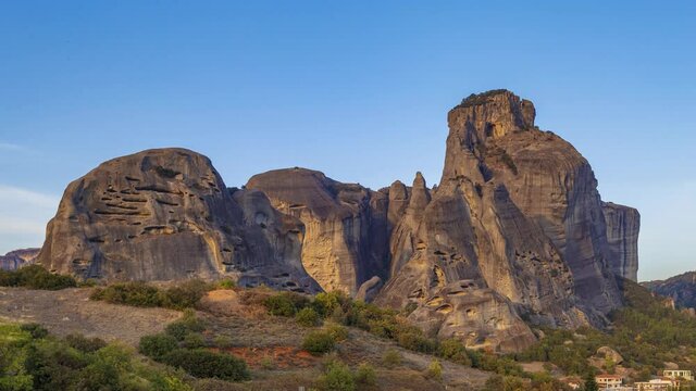 Timelapse 4k, Incredible sunset view of Meteora rock formation and Activities in evening city of Kalabaka, UNESCO World Heritage since 1988, Meteora, City Kastraki, Greece.