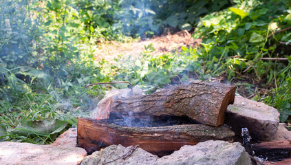 Campfire in nature, making a fire in your garden for cooking meat on an open fire