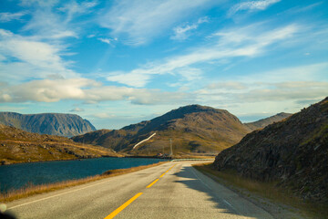 The highway along fjord at sunset. View from the windscreen. Beautiful nature of Norway