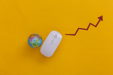 White mouse with, globe, rising arrow on yellow background. Online business, trading. Top view. Flat lay