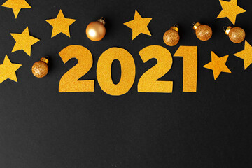 Concept of the year 2021. Golden stars with 2021 numbers on paper background