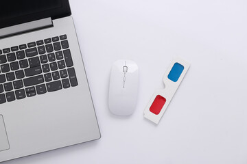 Laptop, PC mouse and anaglyph 3D glasses on white background. Top view. Minimalism