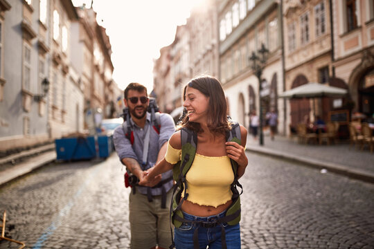Young  man and woman at the Prague.Happy tourists travelling and enjoying on vacation,