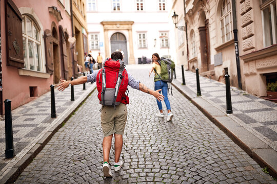 . women and men with backpack in love traveling together at Europe.
