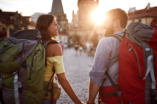 Couple in love walking in the streets of Prague at sunset.Travel, tourism and people concept.