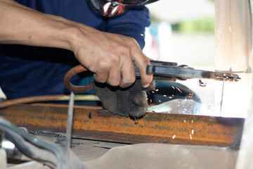 Worker,welding in a car factory with sparks, manufacturing, industry