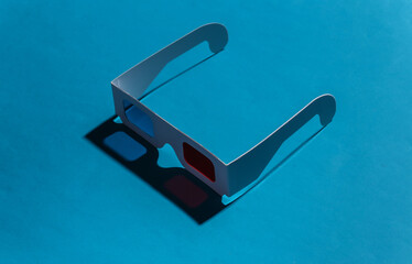 Anaglyph 3D glasses on a blue background with a shadow. Pop Art. 80s