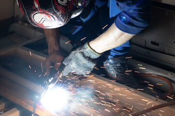Worker,welding in a car factory with sparks, manufacturing, industry