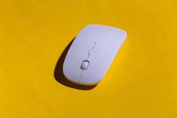 Pc mouse on yellow background with shadow.