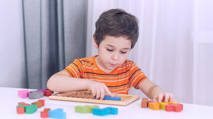 toddler boy playing indoors with educational toy.