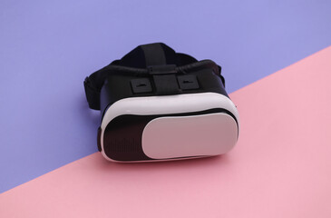 Virtual reality headset on pink purple background. Modern gadgets