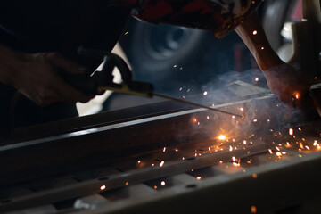 Worker,welding in a car factory with sparks, manufacturing, industry