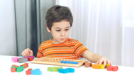 toddler boy playing indoors with educational toy.