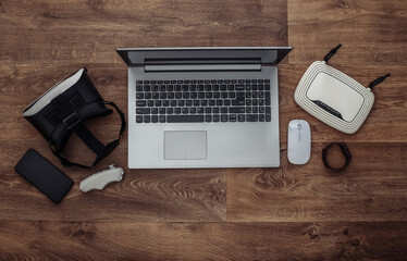 Modern youth gadgets and devices on wooden background. Top view. Flat lay