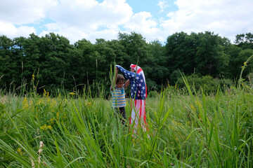 Patriotic holiday.Young boy with American flag.USA celebrate 4th of July.