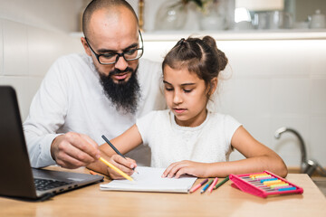 Man helping daughter with homework.