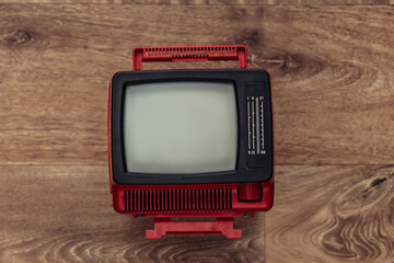Retro portable mini tv on wooden floor