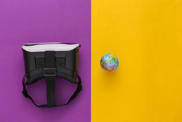 Virtual travel. Virtual reality headset with globe on yellow purple background. Top view