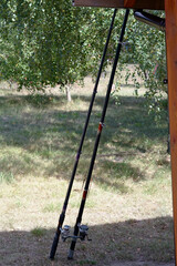 fishing rods leaned against a wooden pole