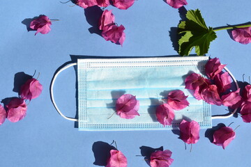 Mask face with flowers on blue background