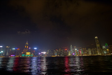 City landscape. Victoria Harbor and Hong Kong skyscrapers at night.
