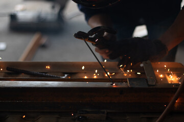 Worker,welding in a car factory with sparks, manufacturing, industry