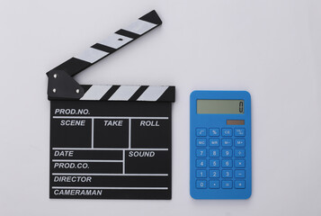 Fototapeta na wymiar Movie clapper board and calculator on white background. Cinema fees. Filmmaking, Movie production. Top view