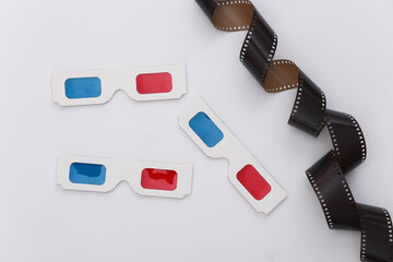 Film tape and 3d glasses on white background. Сinema, Entertainment industry. Top view