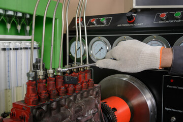 A worker chechs the operation of the fuel system at the stand. Diesel