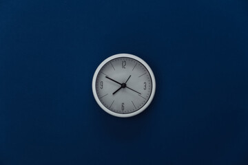 White clock on classic blue background. Color 2020. Top view.