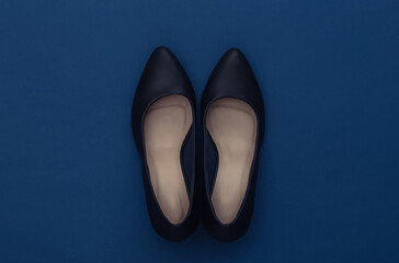 Fashionable leather high heel shoes on a classic blue background. Color 2020. Top view.