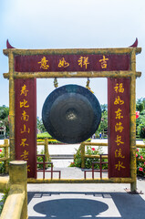 Gate of traditional Chinese architecture with gong in the Sanya Nanshan Cultural Center