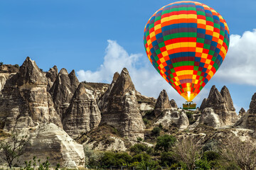 Hot Air Balloons Flying over Valleys in Goreme, Turkey. 