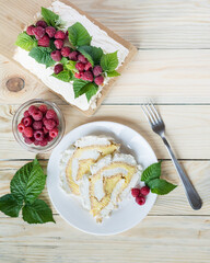 Meringue roll cake with cream and fresh raspberries. Roulade, summer dessert. Vertical orientation,...
