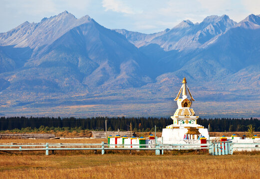 Buddhist stupa against the background of the Eastern Sayan Mountains on an autumn day. Siberia. Baikal region. Buryatia. Tunka valley