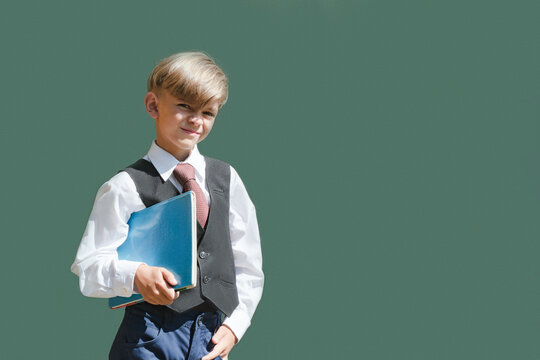 A little boy in full dress uniform is preparing for school