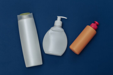 Shampoo bottles on classic blue background. Color 2020. Top view