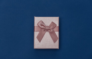 Gift box on classic blue background. Color 2020. Top view