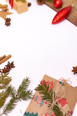 Gifts, Christmas tree branches and cones lie on a white background. Flat lay