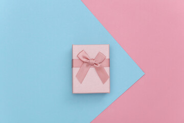 Gift box on pink blue pastel background. Top view.