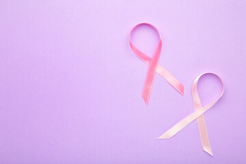 Pink satin breast cancer awareness ribbons on purple