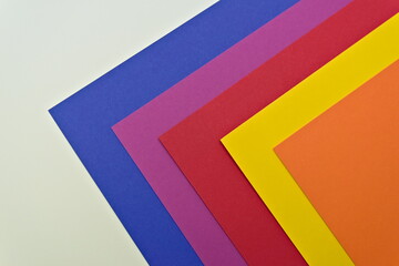 Blue, purple, red, yellow and orange sheets of cardboard paper for arts and crafts projects. isolated on white.